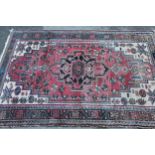 Hamadan rug with a lobed medallion design on a rose ground with cream corner designs and borders,