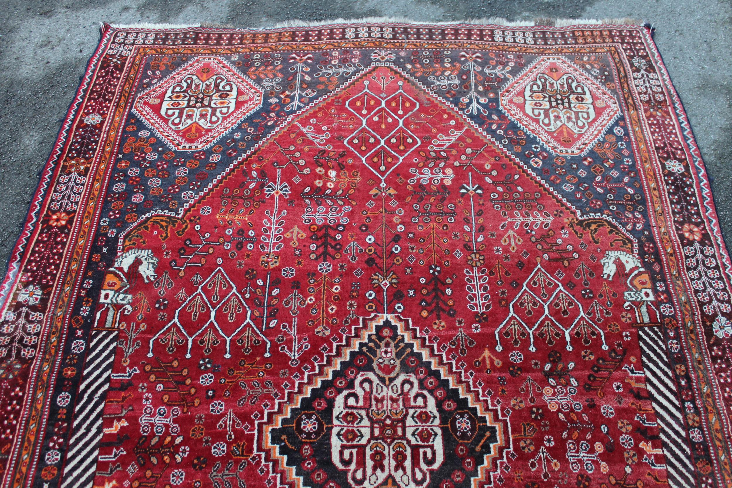 Qashqai rug with central medallion design on red and blue ground with borders, 96ins x 64ins Good - Image 3 of 4
