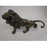 Japanese dark patinated spelter figure of a lion, 11ins high x 17ins wide