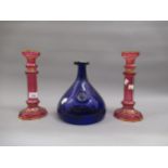Pair of 19th Century Bohemian gilt decorated cranberry glass candlesticks, 10ins high (at fault)