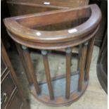 20th Century mahogany semi circular stick stand on turned fluted supports None of the columns have