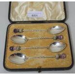 Cased set of four Birmingham silver coffee spoons, the thistle pattern handles with amethyst glass