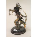 20th Century dark patinated bronze figure of a native Indian, 10.5ins high