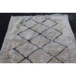 Berber carpet with dark lattice design on cream ground, 7ft x 4ft 10ins approximately