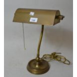 Brass adjustable desk lamp with brass shade, together with a moulded glass table lamp with shade