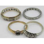 Two eternity rings, small diamond set five stone ring and an unmarked ring with empty setting