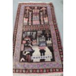 Belouch rug with two panel stylised design on a dark ground with borders, 6ft 4ins x 3ft 4ins