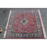 Small Indo Persian rug with a medallion and floral design on a pink ground with borders, 4ft 2ins