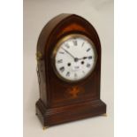 Edwardian mahogany and marquetry inlaid lancet shaped mantel clock, the circular dial with Roman