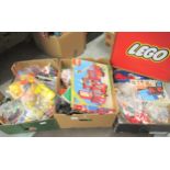 Three boxes containing a large quantity of Megablocks and Lego construction toys together with a