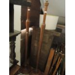 Pair of early 20th Century walnut lamp standards of plain baluster turned design with circular bases