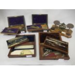 Four cased part sets of drawing instruments, together with a pair of letter scales