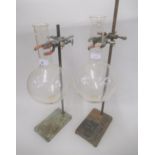 Two chemist's glass boiling vessels mounted on iron laboratory stands