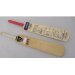 Two miniature cricket bats, one signed by a recent England team