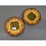 Pair of French Majolica side plates relief moulded with figures, 7.75ins diameter
