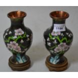 Pair of small cloisonne vases with floral design on a black ground, 6ins high