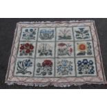 Small needlepoint rug with floral panel design on a cream ground with borders, 3ft 10ins x 3ft