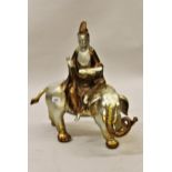 20th Century silvered and gilt patinated bronze figure of a Goddess seated on an elephant, 22.5ins