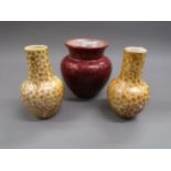 Clement Massier, red lustre floral decorated vase, 5ins high together with a pair of bottle vases