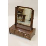 Figured mahogany and crossbanded swing frame toilet mirror with three drawer box base, together with