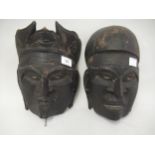 Two Far Eastern patinated wooden native masks