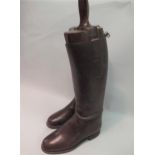 Pair of brown leather riding boots, with wooden trees Approximate size is 7/8 Heel to toe along