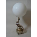 Silvered metal lamp base in the form of a performing seal with an opaque glass globe shade, 22.