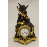 19th Century French dark patinated and gilt bronze mantel clock, the column case surmounted by a