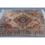 Cotton silk style rug with a medallion and all-over floral design on a cream and rust ground with