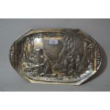 Continental silvered pewter two handled dish decorated in relief with a female figure kneeling at