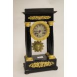 19th Century French ebonised and ormolu mounted portico clock, with a two train movement striking on