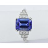 Platinum deco style ring set with a central tanzanite with diamond set shoulders A modern ring in '