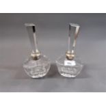 Pair of Continental cut glass and white metal mounted perfume decanters with tall prismatic