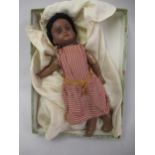 Armand Marseille, small bisque headed doll with a jointed composition body wearing a red striped