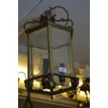 Late 20th Century brass hexagonal three light hall lantern, with bevelled glass panels (at fault)