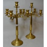 Pair of 20th Century brass five branch candelabra on circular stepped bases, 22.5ins high