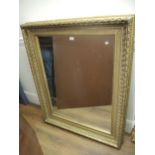 Large 19th Century decorative moulded mirror with original gilding and later plate, 51ins x 41ins