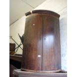 George III mahogany and line inlaid bow fronted two door hanging corner cabinet