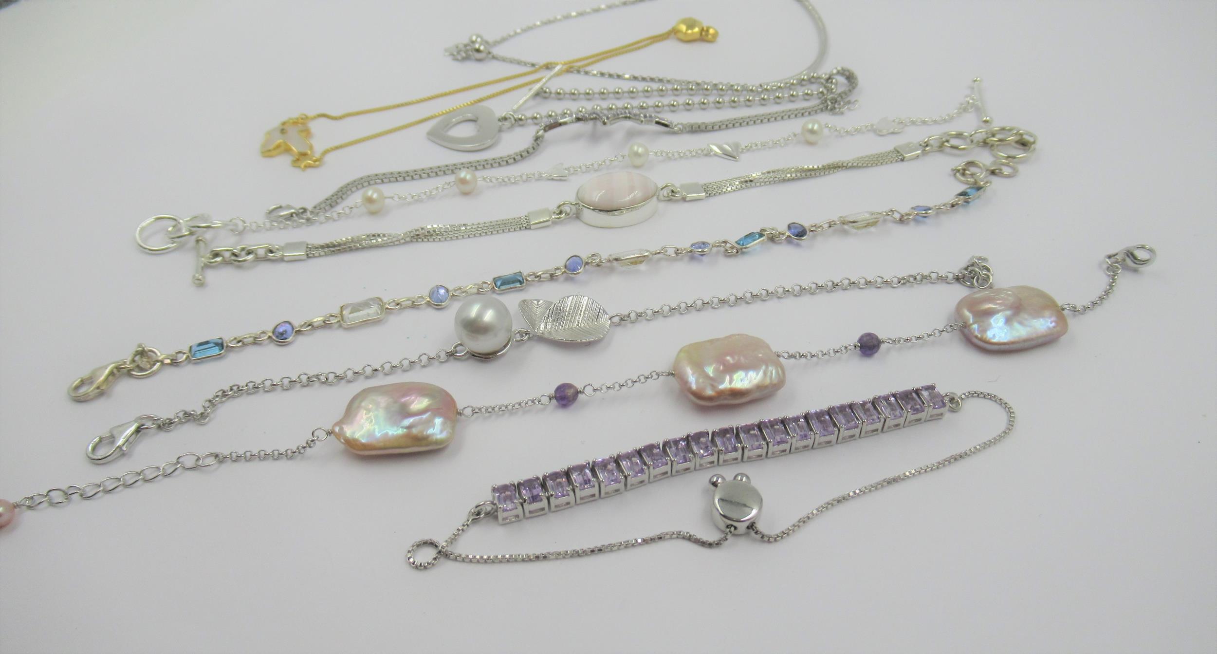 Group of ten various silver bracelets set with various semi precious and gem stones