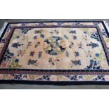 Chinese rug with a centre medallion and all-over design of various objects and flowers within a