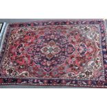 Meshed carpet with medallion and all-over floral design on a rose ground with corner designs and