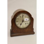 Early 20th Century figured walnut mantel clock with a silvered dial, Roman numerals and two train