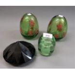 Green glass dump paperweight, pair of floral decorated green glass vases and another glass
