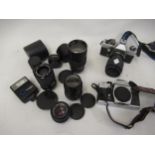Two Praktica camera bodies, together with a quantity of various camera lenses