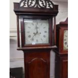 Mahogany longcase clock with a pierced fretwork pediment, square hood and arched panel door, the