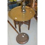 North African engraved brass circular tray on a folding stand, 23ins diameter together with a copper