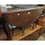 George III oval mahogany gateleg table on turned supports with pad feet