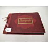 Red photograph album containing a collection of various Chinese photographs and postcards Some