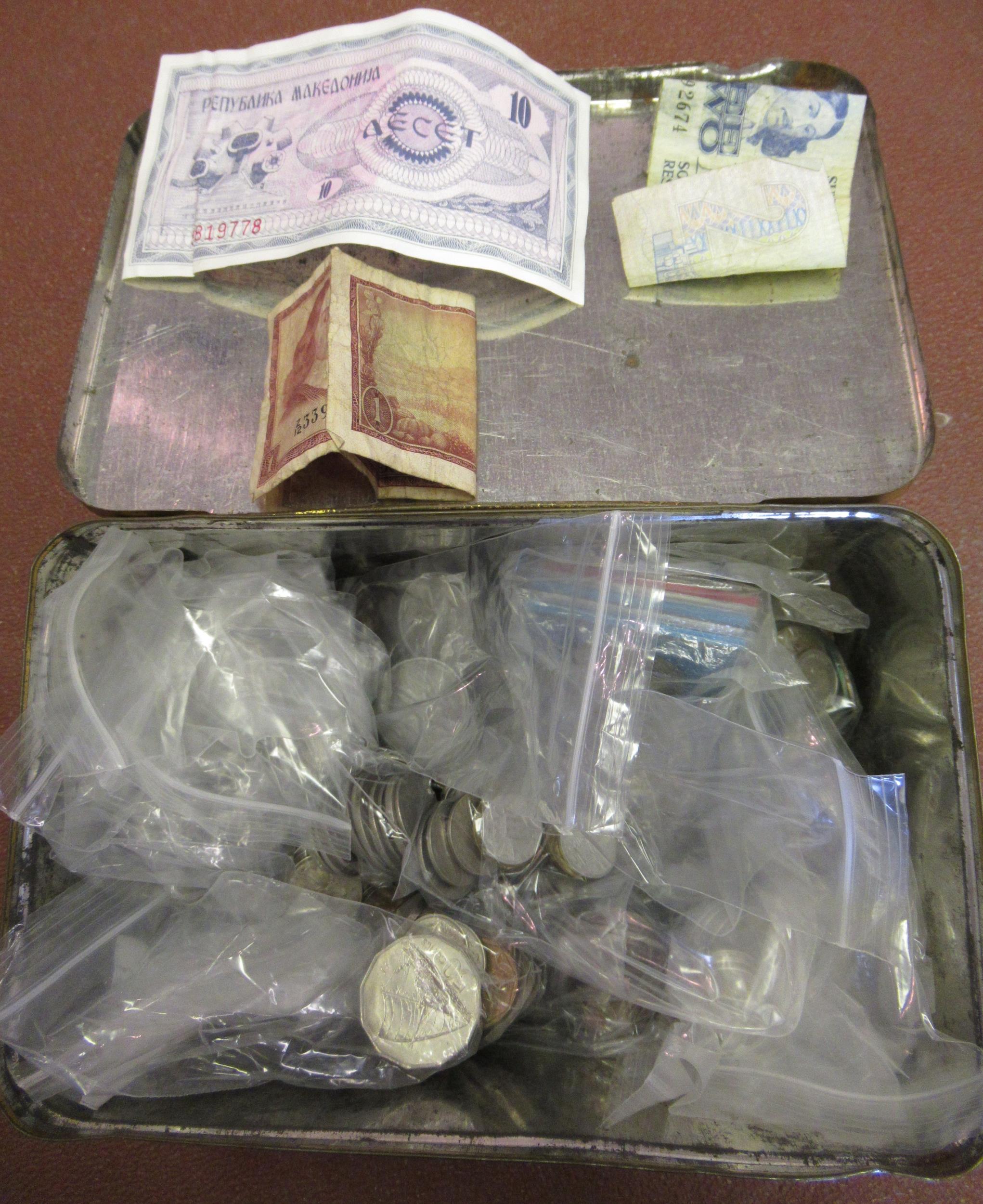 Tin containing a quantity of various World coins and some notes