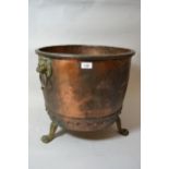 Circular riveted copper coal bin with lion ring handles and three paw supports, 17ins high x 18ins
